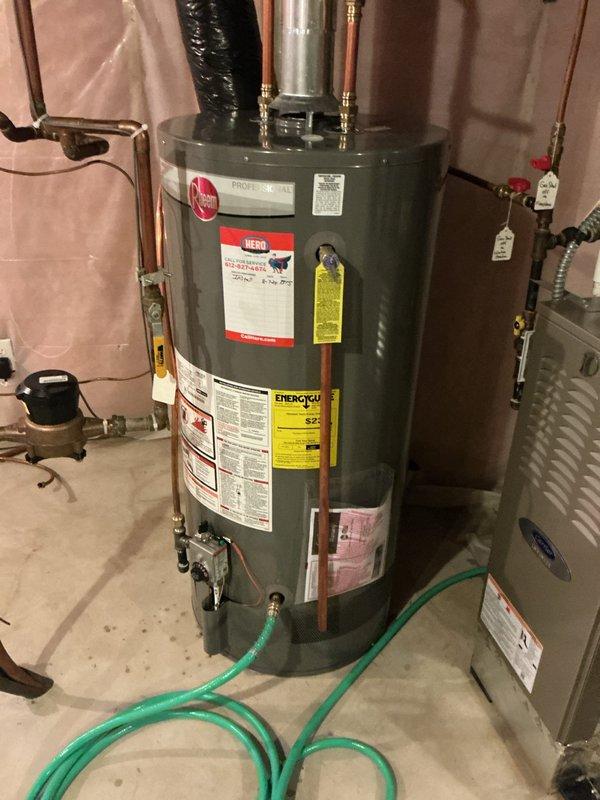 Performed routine maintenance flush on a 3-year-old Proline Power Vent tanked water heater (Model RURD2, 40,000 BTU input, natural gas). Drained sediment buildup from tank to maintain heating efficiency and extend unit lifespan, then refilled system and verified proper operation of all components including power vent assembly and safety mechanisms.