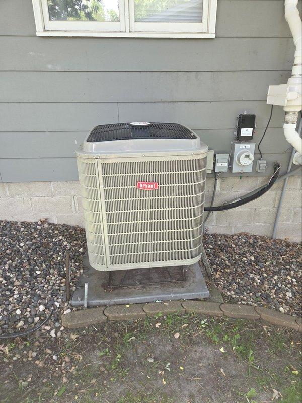 Responded to no-cool condition on 7-year-old Bryant system displaying thermal lockout malfunction message. Found outdoor condenser coil heavily obstructed with cottonwood debris, restricting airflow and causing system protection shutdown. Cleaned condenser coil thoroughly to restore proper airflow. Tested dual run capacitor and found failed (40+5 MFD), replaced with new capacitor. Cycled power at disconnect and reconnected outdoor unit control wiring at thermostat. System started successfully, verified proper temperature split across evaporator coil, confirmed adequate airflow at filter, and tested full cooling cycle. Unit operating within normal parameters upon completion.