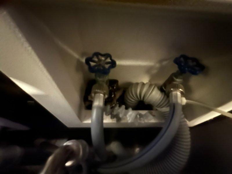 Responded to service call for leaking laundry faucet connections. Successfully replaced both hot and cold water supply valves with new shut-off valves featuring cross-handle controls, resolving the leak issue. Installation completed with proper connections to existing plumbing infrastructure, restoring full functionality to the washing machine water supply system.
