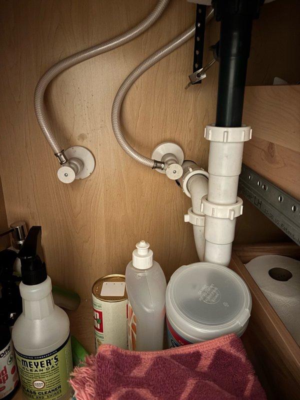 Completed biannual plumbing maintenance inspection including water heater flush, mechanical room water piping inspection, bathroom fixture evaluation throughout the residence, comprehensive drain leak testing, laundry hose inspection, and hard water analysis. All plumbing systems operating properly with no active leaks detected. Kitchen sink plumbing, including braided stainless steel supply lines, shutoff valves, and PVC drain trap assembly, found in good working condition. Water heater noted to be 14 years old and approaching end of typical service life; homeowner advised to monitor for signs of deterioration or failure.
