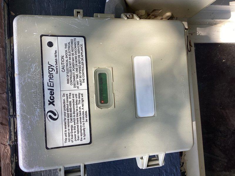 Responded to no cooling complaint and found outdoor unit not operating due to Xcel Energy utility control box malfunction indicated by red warning light. Bypassed utility control box to restore cooling operation and advised customer to contact utility provider for box removal or repair. Performed annual maintenance inspection on condensing unit, cleaned heavily soiled condenser coils, verified refrigerant pressures and electrical components, and confirmed system operating within normal parameters upon completion.