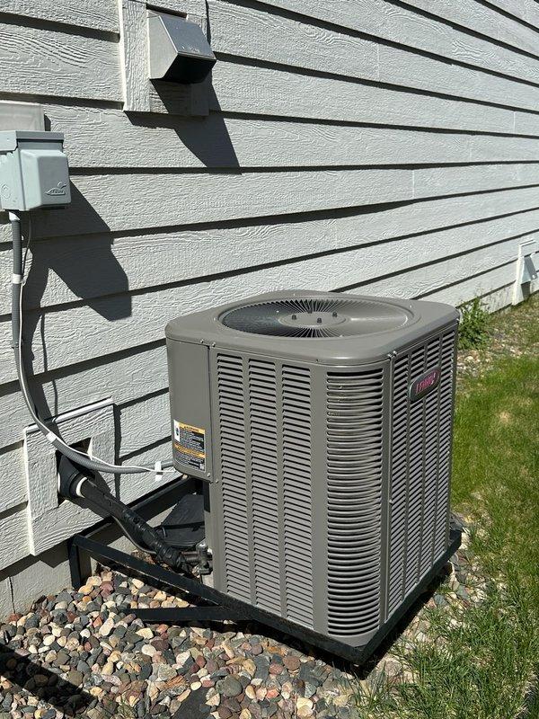 Responded to no cooling complaint on 11-year-old residential air conditioning system. Upon arrival, confirmed unit was blowing warm air with no visible condensation at outdoor unit. Verified thermostat was properly calling for cooling mode. Performed comprehensive diagnostic inspection of outdoor condenser unit including visual examination of coil condition, capacitor operation, and refrigerant charge level. System found to be significantly low on refrigerant. Proceeded to indoor air handler where evaporator coil was discovered to be partially iced up, consistent with low refrigerant charge. Based on ice formation pattern and refrigerant loss, diagnosed probable refrigerant leak in system. Homeowner reported that another HVAC contractor had previously added 4 pounds of refrigerant to system, confirming ongoing leak issue. Presented repair options including leak detection dye injection and refrigerant recharge to temporarily restore cooling operation. Homeowner declined repair services 