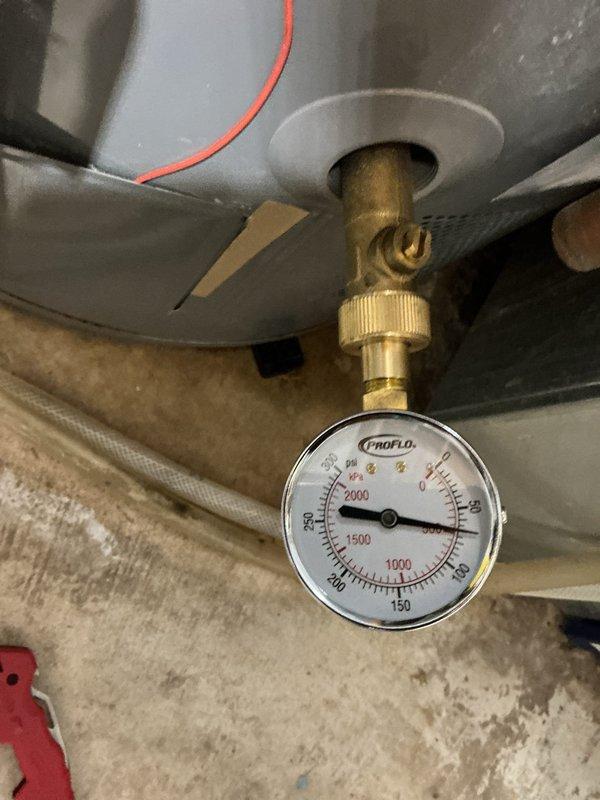 Responded to service call for recently installed water heater with water accumulation around base of unit. Performed comprehensive leak testing and pressure diagnostics on tankless water heater system. Inspected temperature and pressure relief valve, overflow piping, and all connection points. Testing confirmed proper system pressure within normal operating parameters. Determined moisture was condensation related to recent installation rather than active leak. Verified all fittings, valves, and connections were secure with no signs of active water seepage.