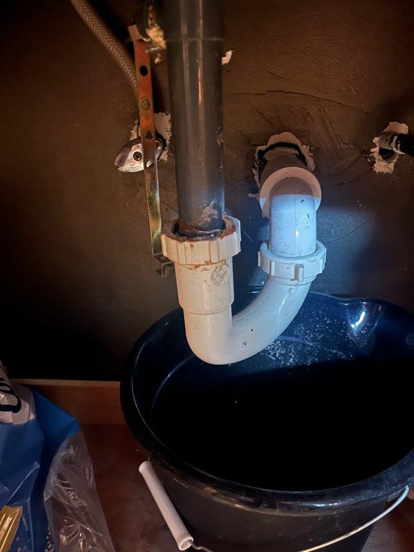 Installed customer-supplied waterfall-style lavatory faucet with glass spout and oil-rubbed bronze finish on bathroom vanity with granite countertop. Addressed clogged drain issue and completed minor drain repairs, including work on P-trap assembly and PVC drainage system beneath sink. Resolved slight leak in existing plumbing connections and ensured proper water flow through new faucet installation.