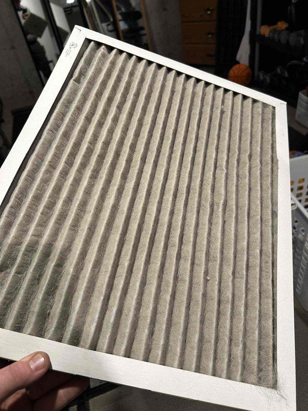 Responded to no cooling complaint on 9-year-old system with weak airflow and handler condensation. Found system low on refrigerant charge and heavily soiled air filter restricting airflow. System has history of previous refrigerant leak repairs including condenser leak and TXV replacement, indicating potential additional leak in system. Added refrigerant to restore proper charge levels, achieving target subcooling of approximately 7 degrees. Injected UV dye into system for future leak detection. System restored to proper cooling operation upon departure.