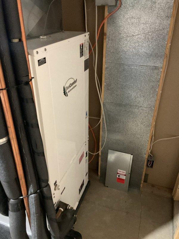 Responded to no cooling complaint on 16-year-old GeoComfort geothermal heat pump system affecting entire home. Upon inspection, discovered unit was completely out of refrigerant with no visible oil residue inside the cabinet, indicating a potential leak in the coaxial coil. Given the age of the system at approximately 16-18 years and the complete loss of refrigerant charge, recommended full system replacement rather than repair. Documented equipment condition with photos and scheduled follow-up consultation to discuss replacement options.