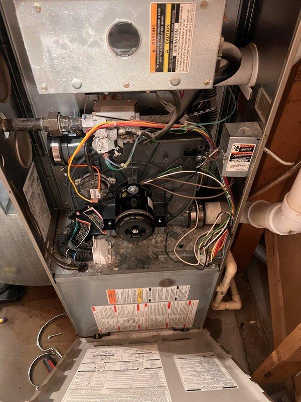 Responded to no-cooling complaint on 2005 Bryant PLUS 90 system with evaporator coil freeze-up. Upon arrival, found outdoor condenser coils clean and evaporator coil free of debris with clear condensate drain. Connected manifold gauges and observed refrigerant charge slightly below optimal range for R-22 system but within marginal operating parameters. Customer had recently installed MERV 11 air filter, which was determined to be excessively restrictive for this system's blower capacity, resulting in reduced airflow across evaporator coil and subsequent ice formation. After filter had been in place approximately 24 hours, coil began normal condensation cycle and ice buildup ceased. Verified airflow restoration and monitored system operation until cooling function returned to normal. Advised customer that R-22 refrigerant is no longer serviced and system replacement should be considered due to age and refrigerant phase-out, though current operation is functional for continued use.