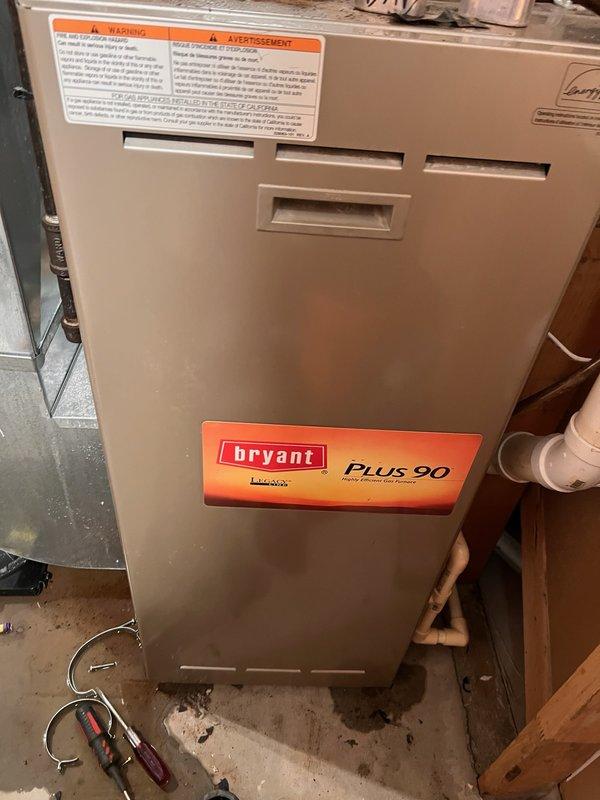 Responded to no-cooling complaint on 2005 Bryant PLUS 90 system with evaporator coil freeze-up. Upon arrival, found outdoor condenser coils clean and evaporator coil free of debris with clear condensate drain. Connected manifold gauges and observed refrigerant charge slightly below optimal range for R-22 system but within marginal operating parameters. Customer had recently installed MERV 11 air filter, which was determined to be excessively restrictive for this system's blower capacity, resulting in reduced airflow across evaporator coil and subsequent ice formation. After filter had been in place approximately 24 hours, coil began normal condensation cycle and ice buildup ceased. Verified airflow restoration and monitored system operation until cooling function returned to normal. Advised customer that R-22 refrigerant is no longer serviced and system replacement should be considered due to age and refrigerant phase-out, though current operation is functional for continued use.