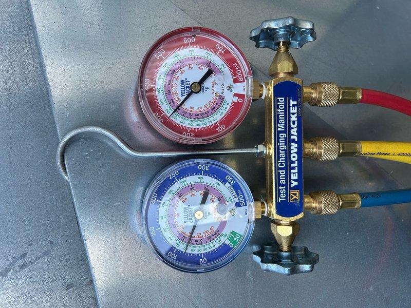 Responded to no cooling complaint on commercial showroom rooftop unit. Upon arrival, found system calling with blower operational but compressors failing to engage. Cycled power multiple times; compressors would run briefly before tripping on high pressure safety. Initially only one condenser fan motor would start during power cycles. Identified heavily fouled condenser coil as root cause of high pressure condition. Performed condenser coil cleaning, which restored proper airflow and system operation. Verified both compressors and condenser fans now operating correctly with normal pressures. Noted dirty air filters and worn fan belt requiring future replacement. System restored to full cooling capacity. Recommended comprehensive tune-up maintenance for this unit and secondary office RTU to prevent similar issues.