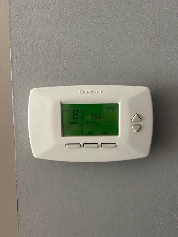 Responded to no cooling complaint with reported loud humming noise from indoor unit. Upon arrival, verified thermostat calling for cooling with evaporator supply air temperature exceeding 60°F. Inspected outdoor condenser unit and confirmed capacitor, contactor, and fan motor operating within normal parameters. Diagnostic testing revealed system operating with insufficient refrigerant charge, evidenced by abnormally high liquid line temperature and lack of cooling capacity. Documented findings with photos of thermostat display and condenser unit diagnostics. Recommended comfort advisor consultation to provide customer with repair and replacement options due to refrigerant loss requiring further evaluation for leak source and system viability.