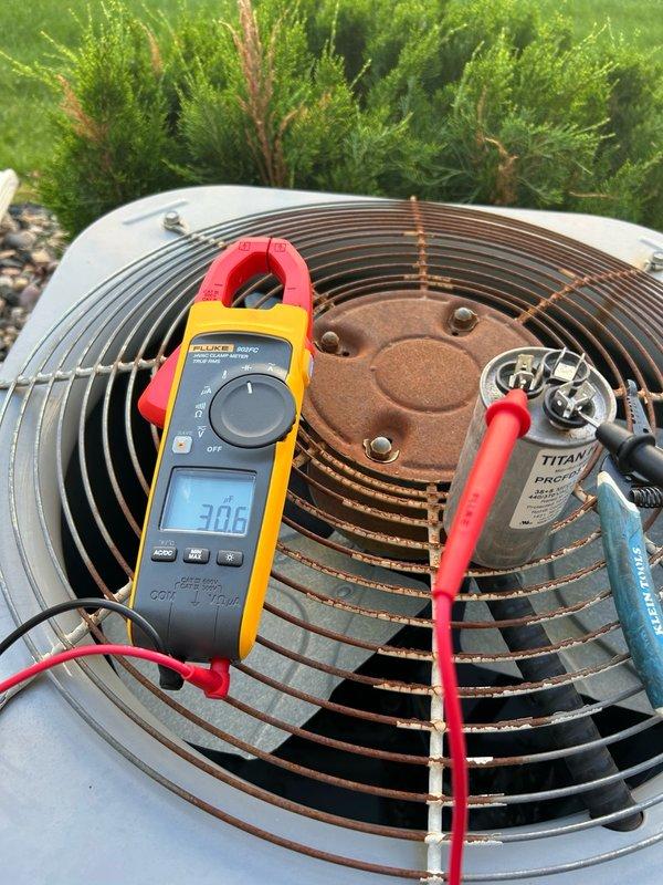 Responded to no cooling complaint with reported loud humming noise from indoor unit. Upon arrival, verified thermostat calling for cooling with evaporator supply air temperature exceeding 60°F. Inspected outdoor condenser unit and confirmed capacitor, contactor, and fan motor operating within normal parameters. Diagnostic testing revealed system operating with insufficient refrigerant charge, evidenced by abnormally high liquid line temperature and lack of cooling capacity. Documented findings with photos of thermostat display and condenser unit diagnostics. Recommended comfort advisor consultation to provide customer with repair and replacement options due to refrigerant loss requiring further evaluation for leak source and system viability.