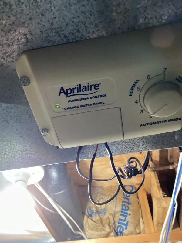 Responded to service call for non-operational air exchanger following recent AC installation. Upon inspection, discovered air exchanger unit was functional but all control wiring had been disconnected from the control panel. Unable to determine original wiring configuration or connection points. Documented existing conditions with photos showing Aprilaire humidifier control and furnace installation. Recommended follow-up visit with senior technician for proper air exchanger control wiring diagnosis and restoration.