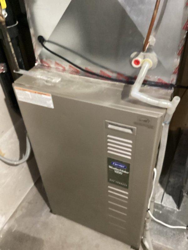 Responded to service call for non-operational air exchanger following recent AC installation. Upon inspection, discovered air exchanger unit was functional but all control wiring had been disconnected from the control panel. Unable to determine original wiring configuration or connection points. Documented existing conditions with photos showing Aprilaire humidifier control and furnace installation. Recommended follow-up visit with senior technician for proper air exchanger control wiring diagnosis and restoration.