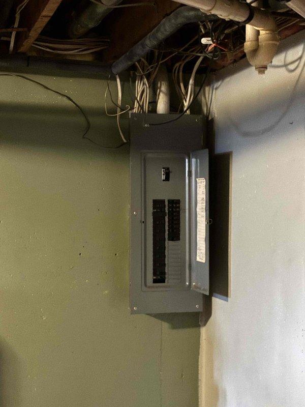 Responded to no cooling complaint on 3-year-old air conditioning system with thermostat set to 70°F but indoor temperature reading 79°F. Upon arrival, found system shut down with only fan operational. Discovered rodent remnants (squirrel or mouse) in outdoor electrical panel with damaged wiring, and condenser coil severely obstructed with debris. Repaired broken wire by installing new spade connector to restore electrical connection. Disassembled and thoroughly cleaned condenser coil to restore proper airflow and heat transfer. Performed complete system inspection including all electrical components, verified air filter condition (found clean), checked refrigerant charge and temperature differential across evaporator coil, confirmed proper coil sweating pattern indicating adequate refrigerant flow, and cleared condensate drain line. System restored to proper cooling operation. Advised customer that due to elevated indoor temperature exceeding 80°F, system would require extended runtime