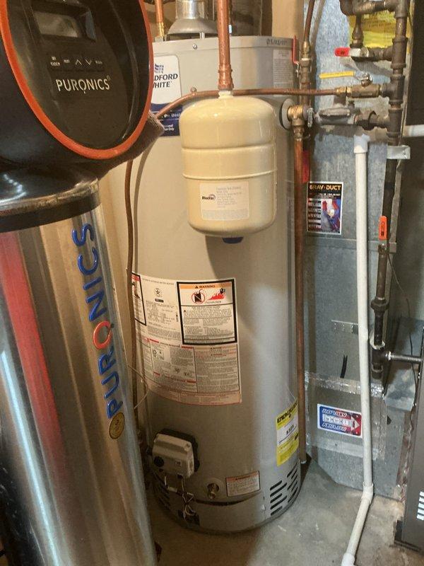 Responded to no cooling complaint on 6-year-old Lennox system that had frozen up the previous day. Upon arrival, unit had thawed and was operational. Performed diagnostic testing and found restrictive air filter which was removed. Verified fan speed settings were correct. Monitored subcooling readings which initially fluctuated between 10-17°F before stabilizing at 10-12°F within acceptable range. Confirmed proper temperature split across evaporator coil. Checked suction line temperature and saturated suction temperature, both reading normal. Evaluated potential TXV or filter drier restriction by measuring temperature differential across filter drier, which showed 2°F difference indicating proper flow. Verified TXV insulation was installed correctly. All system parameters returned to normal operating conditions after allowing adequate runtime. Recommended customer switch to MERV 5 rated filter and maintain monthly replacement schedule to prevent future freeze-ups due to airflow restric