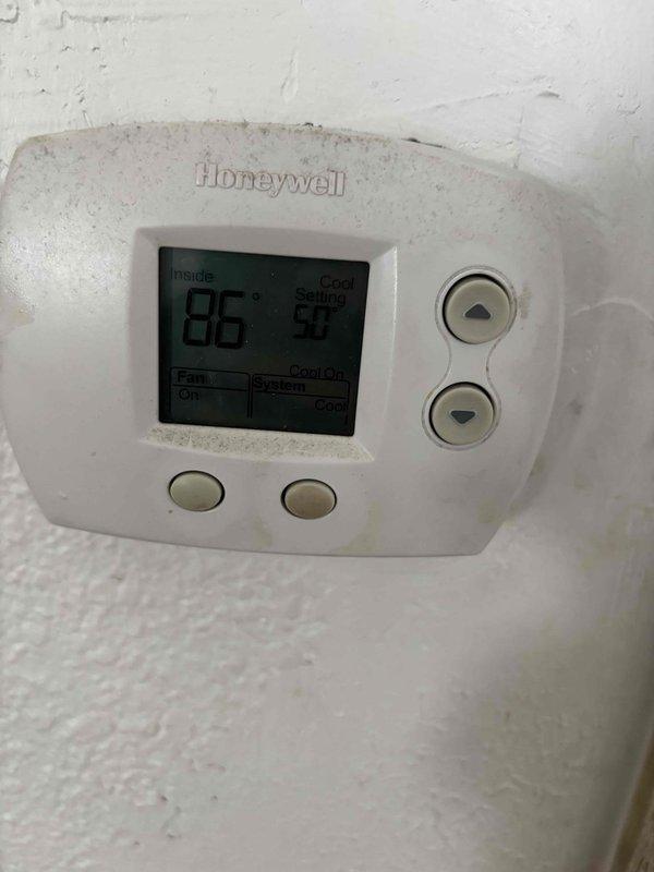 Responded to no cooling complaint on residential HVAC system. Upon arrival, verified thermostat calling for cooling and checked indoor unit components including filter, condensate drain, and blower motor, all found operational. Proceeded to outdoor unit where condenser fan motor operated but compressor failed to start. Diagnosed failed dual-run capacitor (40+5 MFD) preventing compressor operation and replaced with new capacitor. During inspection, found outdoor condenser coil heavily soiled with debris, restricting airflow and reducing system efficiency. Thoroughly cleaned and rinsed condenser coil to restore proper heat transfer. After repairs, verified system operation with compressor running properly. Measured temperature split across evaporator coil at 20 degrees, confirming adequate cooling performance. System restored to normal operation with proper airflow and refrigeration cycle functioning as designed.