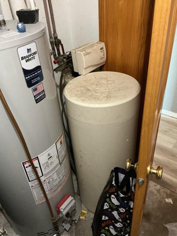 Responded to no cooling complaint on residential AC system with water leaking from furnace. Cleared plugged evaporator drain line that was causing overflow at top of furnace cabinet. Upon startup, diagnosed elevated head pressure at outdoor unit. Removed condenser top panel and extracted mouse nest from unit base, then pressure washed condenser coils to restore proper airflow. Reassembled unit and verified system operation with 20° temperature split across evaporator coil, confirming proper cooling performance restored.