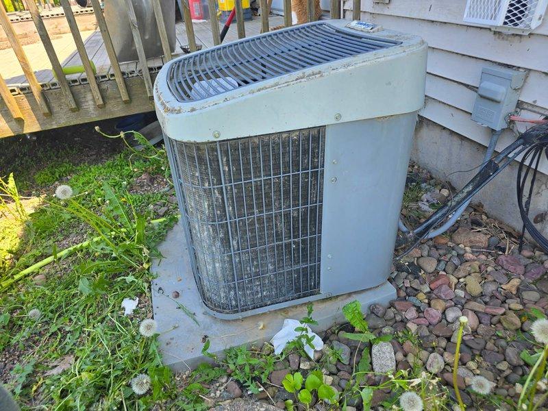 Responded to no cooling call on 15+ year old Tempstar SmartComfort 2000 R22 system. Found mice had infiltrated outdoor unit causing contactor to fail - debris prevented contacts from closing properly. Cleaned contactor assembly and removed all rodent material from unit. Checked system operation and measured refrigerant pressures - unit slightly low on R22 but achieving 20-degree temperature split across evaporator coil. Noted condenser coil significantly plugged on back side, restricting airflow. Customer elected to defer coil cleaning and operate unit as-is to extend remaining service life. System restored to operational status but advised of potential freeze-up risk due to low refrigerant charge. Prepared estimate for contactor replacement as preventive measure given age of component and recent contamination. Unit functional at time of departure.