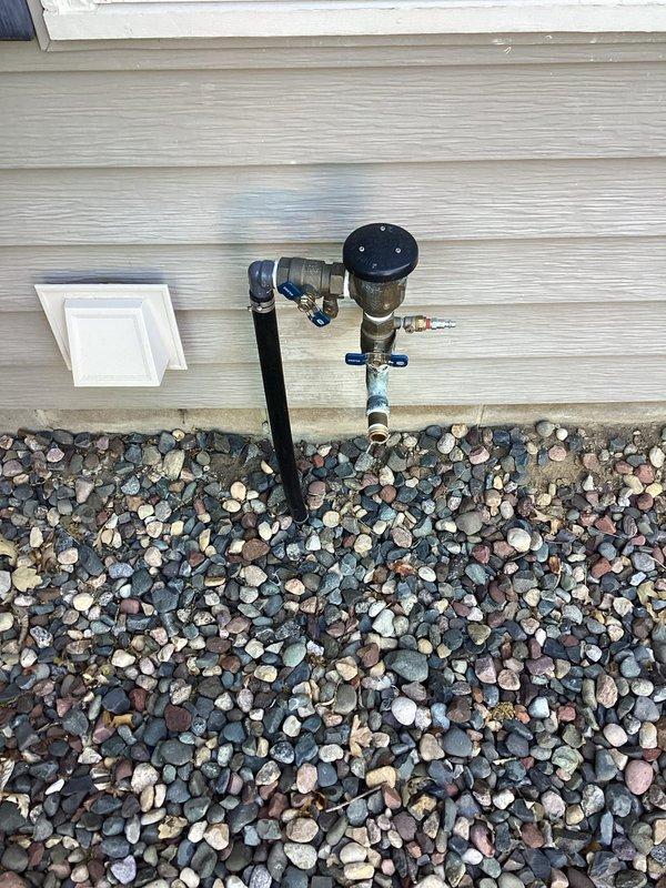 Responded to corroded outdoor spigot with spray leakage and broken valve connected to irrigation system. Addressed missing spigot end and leak at irrigation connection point. Performed testing and tagging of pressure vacuum breaker (PVB), replaced faulty vacuum breaker assembly with new unit, and provided estimate for pressure reducing valve (PRV) installation.
