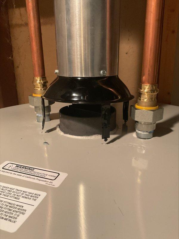 Responded to a correction notice regarding an improperly connected water heater vent system. Upon inspection, found the draft hood had popped up and was not secured to the top of the water heater, causing the vent pipe to disconnect. Pulled the draft hood back into proper position, adjusted the vent 90-degree elbow to provide additional length for secure connection, and reattached all components. Installed screws through the draft hood into the water heater top to prevent future displacement and ensure proper venting. Documented the completed repair with photographs for inspector review.
