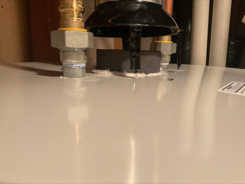 Responded to a correction notice regarding an improperly connected water heater vent system. Upon inspection, found the draft hood had popped up and was not secured to the top of the water heater, causing the vent pipe to disconnect. Pulled the draft hood back into proper position, adjusted the vent 90-degree elbow to provide additional length for secure connection, and reattached all components. Installed screws through the draft hood into the water heater top to prevent future displacement and ensure proper venting. Documented the completed repair with photographs for inspector review.
