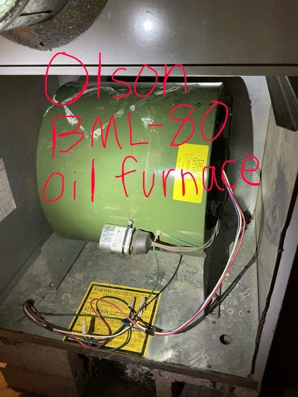 Responded to no cooling complaint with loud buzzing noise at furnace during AC operation. Upon inspection, diagnosed failed blower motor in oil furnace that would not spin freely and produced loud buzzing sound when energized. Tested motor at multiple speed taps to confirm complete motor failure. Provided replacement estimate for blower motor assembly. Homeowner elected to self-install replacement motor. Restored system to powered-off state and documented findings with photos of failed motor assembly.