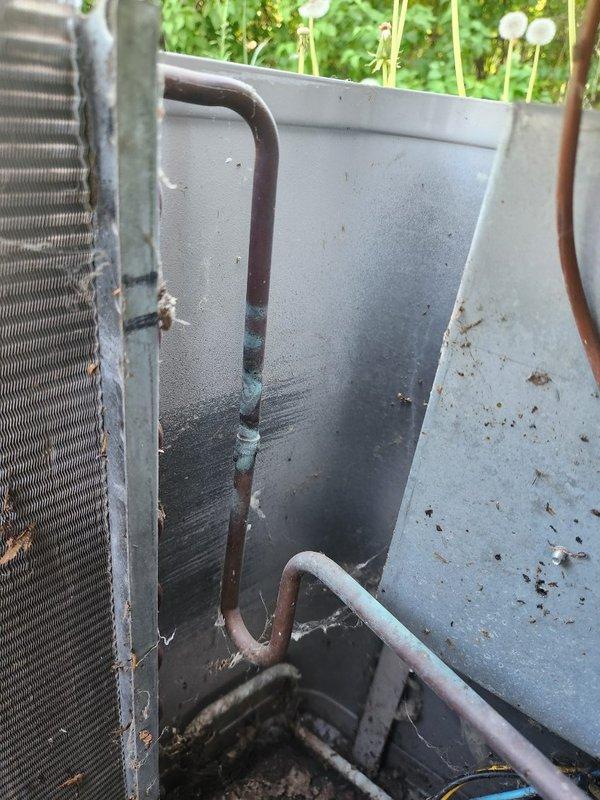Responded to no cooling complaint on 27-year-old residential air conditioning system. Upon arrival, found unit blowing air but producing no cooling. Diagnostic testing revealed system was essentially flat on HCFC-22 refrigerant. Observed missing service port caps and heavily contaminated condenser coil with significant debris accumulation and corrosion. Noted original 1980s furnace also present in system. Due to age of equipment, extensive deterioration, and refrigerant loss, recommended full system replacement. Scheduled follow-up appointment to provide replacement options for both air conditioning unit and furnace.