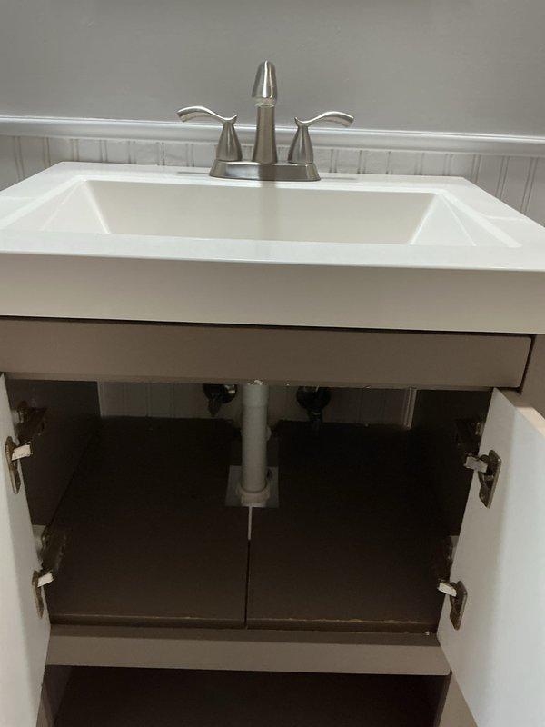 Completed comprehensive plumbing inspection of vacant residential property and documented multiple code deficiencies and hazardous conditions. Provided detailed photographic documentation of bathroom vanity fixture with PVC drain assembly and HVAC system plumbing connections, then prepared separate itemized estimates categorizing repairs by hazardous violations versus below-minimum code requirements for property compliance.