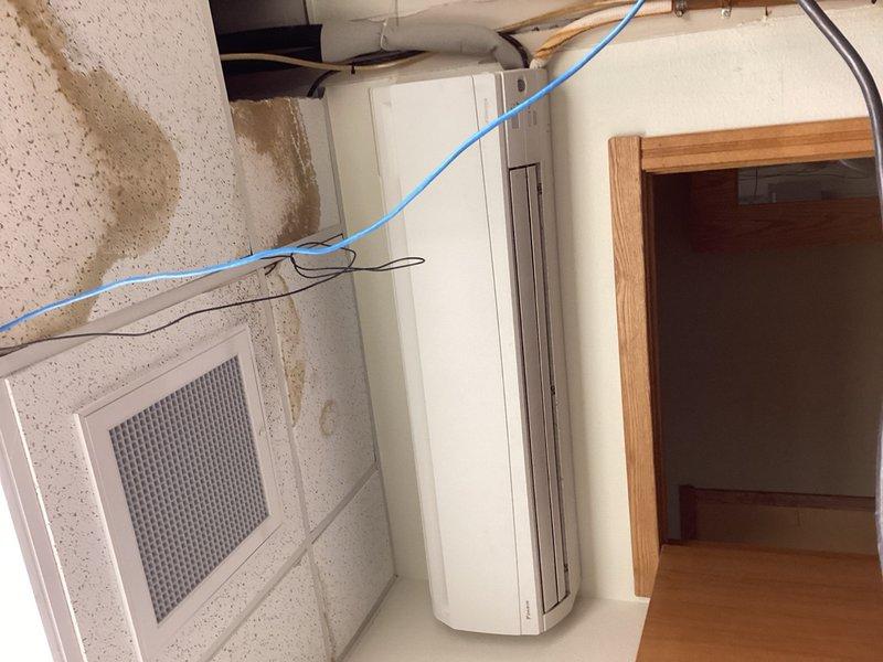 Responded to no cooling complaint on 6-year-old mini split system. Upon arrival, found indoor head unit unresponsive to cooling calls and outdoor condenser unit not operating. Diagnostic inspection of outdoor unit revealed broken condenser fan blade wedged in fan assembly, preventing operation. Assessed potential motor damage due to stress from broken fan wheel. Recommended replacement of both condenser fan blade and motor to ensure reliable operation and prevent future failure. Part order forms submitted for required components and documented system condition with photographs.