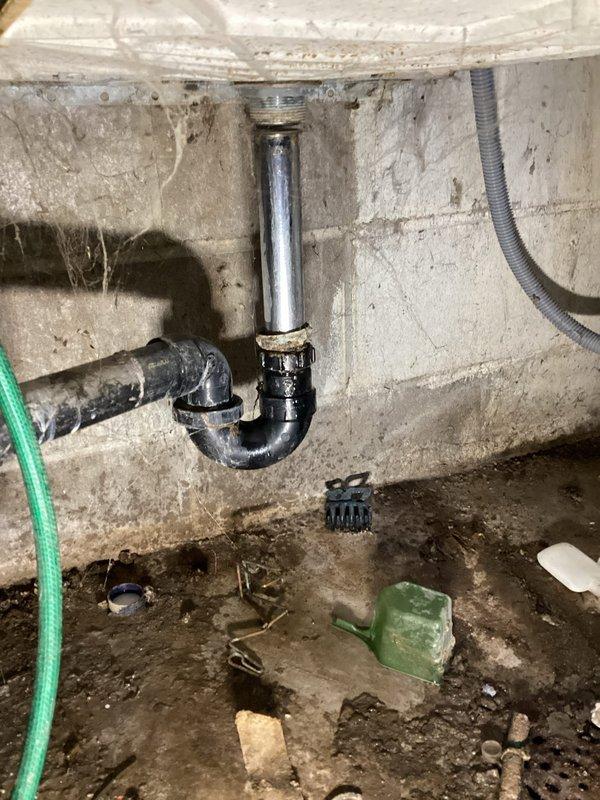 Responded to service call for weak toilet flush and plumbing leaks in basement utility area. Upon inspection, identified plugged fill valve causing inadequate flushing performance and discovered active leak at P-trap assembly beneath toilet draining into floor drain. Additional leak found at main shutoff valve supplying laundry area. Replaced defective toilet fill valve and deteriorated supply line to restore proper flush function. Installed new main shutoff valve to eliminate leak at laundry connection. Replaced flanged tailpiece on drain assembly to resolve P-trap leak. All connections tested and verified leak-free. System restored to full operational capacity with proper water flow and drainage confirmed.