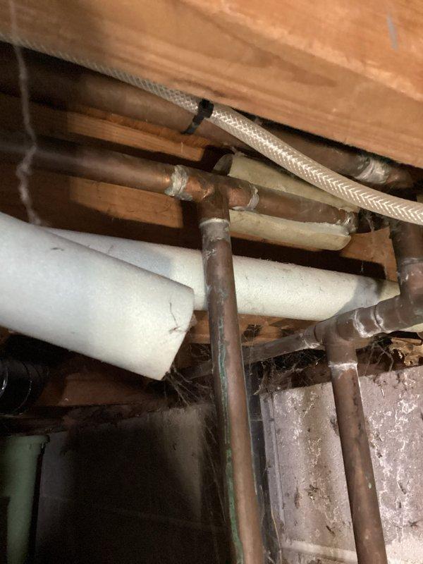 Responded to service call for weak toilet flush and plumbing leaks in basement utility area. Upon inspection, identified plugged fill valve causing inadequate flushing performance and discovered active leak at P-trap assembly beneath toilet draining into floor drain. Additional leak found at main shutoff valve supplying laundry area. Replaced defective toilet fill valve and deteriorated supply line to restore proper flush function. Installed new main shutoff valve to eliminate leak at laundry connection. Replaced flanged tailpiece on drain assembly to resolve P-trap leak. All connections tested and verified leak-free. System restored to full operational capacity with proper water flow and drainage confirmed.