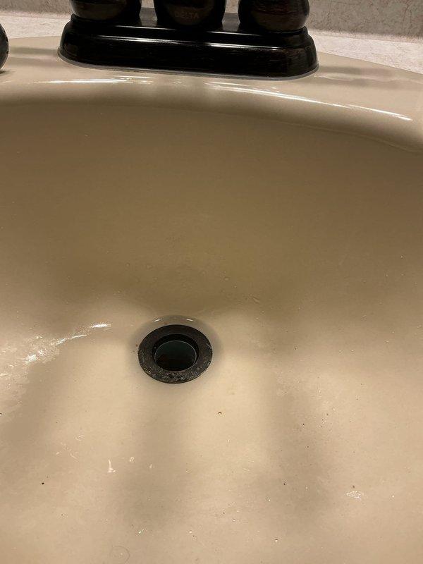 Responded to a clogged bathroom lavatory sink drain that was backing up during use. Diagnostic assessment confirmed the blockage was isolated to the lavatory sink drain line with no other fixtures affected. Cabled the drain line and successfully removed a significant accumulation of hair and sludge buildup causing the obstruction. Upon reassembly, discovered the existing tubular trap was leaking and required replacement. Installed a new tubular trap assembly under the lavatory sink to ensure proper seal and drainage. Conducted final testing to verify proper drain operation and confirmed no leaks were present at any connections.