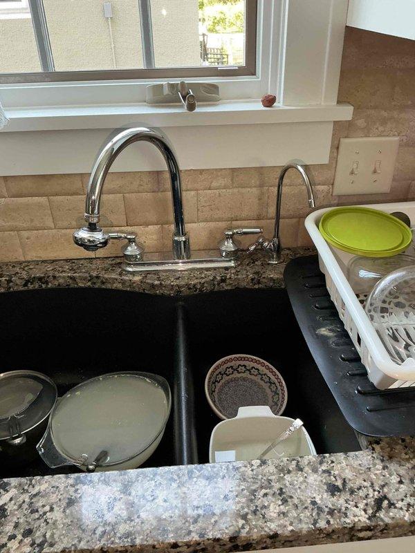 Completed comprehensive plumbing inspection including water heater maintenance service consisting of draining and refilling unit per customer request upon new membership enrollment. Inspected kitchen plumbing components including garbage disposal, P-trap assembly, and drain line connections, all found to be in proper working order with no leaks or deficiencies observed.