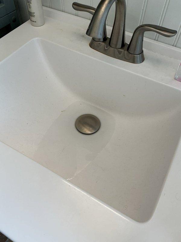 Responded to multiple drain backing issues affecting the main floor bathroom and basement plumbing system. Conducted diagnostic testing by running water through the laundry sink drain and tub for approximately 30 minutes while monitoring the basement floor drain and toilet for backup conditions. Testing confirmed the mainline was open and functioning properly with no blockages present in the primary sewer line.

Identified the upstairs lavatory sink drain as blocked with accumulated hair buildup. Cabled the drain and successfully removed a large amount of hair causing the obstruction. Tested the lavatory sink drain for proper operation and confirmed normal drainage with no leaks present. 

Evaluated the main floor toilet and determined the unit is old and requires replacement due to poor flushing performance. Scheduled return visit for toilet replacement to resolve ongoing flushing issues.