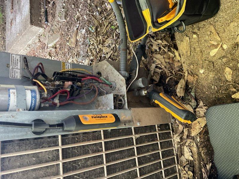 Responded to no cooling complaint on 33-year-old R-22 system experiencing freeze-up conditions and inadequate cooling performance. Upon arrival, unit was off per homeowner request to prevent potential furnace damage. Visual inspection revealed outdoor unit surrounded by debris including leaves and mulch accumulation around base and perimeter. Confirmed system age at 33+ years, significantly older than homeowner's initial estimate. 

Observed evidence of previous line set freezing based on customer report of frost formation prior to system shutdown. System exhibited minimal cooling output before freeze-up occurred. Preliminary assessment indicated low refrigerant charge and dirty condenser coil contributing to performance issues. Electrical components and wiring inspected during service call. 

Given the age of the equipment, R-22 refrigerant type, apparent refrigerant loss, compromised coil condition, and debris accumulation affecting airflow, recommended emergency replacement consulta