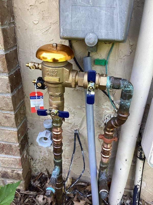 Replaced defective pressure vacuum breaker (PVB) backflow prevention device up to 1" on exterior water supply system. Removed and replaced cracked ball valve that was compromising system integrity. Installation included new brass PVB assembly with proper copper and PVC connections within 10 feet of supply point, ensuring compliance with backflow prevention requirements and restoring safe water supply operation.