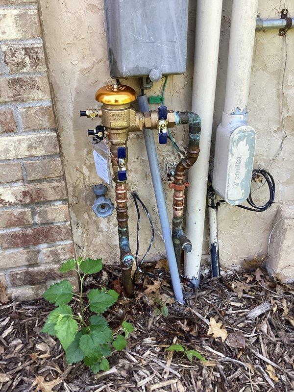 Replaced defective pressure vacuum breaker (PVB) backflow prevention device up to 1" on exterior water supply system. Removed and replaced cracked ball valve that was compromising system integrity. Installation included new brass PVB assembly with proper copper and PVC connections within 10 feet of supply point, ensuring compliance with backflow prevention requirements and restoring safe water supply operation.