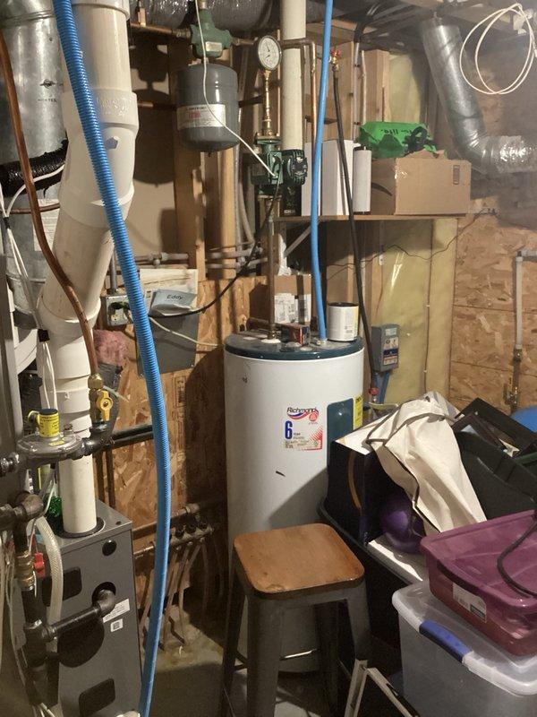Responded to complaint of strong sewer odor in basement. Upon inspection, identified dry floor drain trap as source of sewer gas infiltration. Poured water down floor drain to restore trap seal, eliminating odor issue. 

Addressed leaking hose bib that had not been operated in several years. Tightened packing screw on hose bib stem, reducing leak from constant drip to slow intermittent drip. Advised homeowner to cycle valve over weekend to monitor performance. Noted hose bib location behind finished wall and wood paneling; discussed stem replacement as potential future repair if tightening does not resolve leak completely.

Inspected main floor bathroom faucet with drip on hot water side. Tightened collar nut on faucet assembly, successfully stopping drip. Verified all repairs and confirmed resolution of initial concerns.