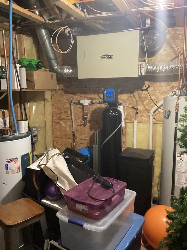 Responded to complaint of strong sewer odor in basement. Upon inspection, identified dry floor drain trap as source of sewer gas infiltration. Poured water down floor drain to restore trap seal, eliminating odor issue. 

Addressed leaking hose bib that had not been operated in several years. Tightened packing screw on hose bib stem, reducing leak from constant drip to slow intermittent drip. Advised homeowner to cycle valve over weekend to monitor performance. Noted hose bib location behind finished wall and wood paneling; discussed stem replacement as potential future repair if tightening does not resolve leak completely.

Inspected main floor bathroom faucet with drip on hot water side. Tightened collar nut on faucet assembly, successfully stopping drip. Verified all repairs and confirmed resolution of initial concerns.