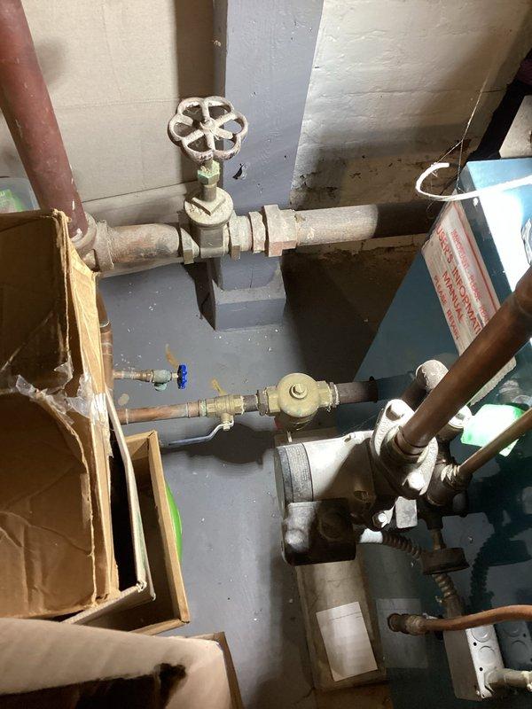 Responded to municipal Order to Correct regarding missing backflow preventer on boiler system. Inspected existing plumbing assembly and confirmed air gap backflow protection was present. Installed vacuum breaker to bring system into compliance with code requirements and documented work with photographs.