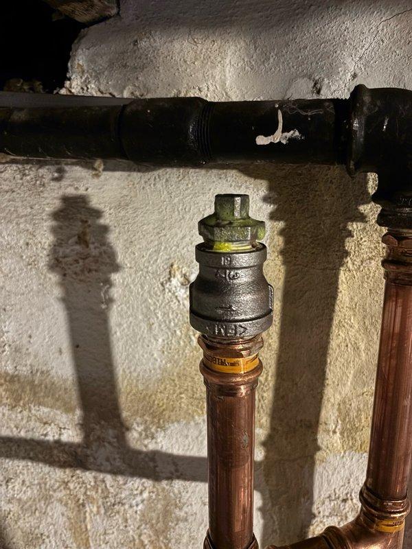 Responded to return visit for tankless water heaters experiencing recurring beeping errors due to insufficient gas pressure. Relocated the soft copper gas supply line from the low-pressure side to the high-pressure side of the main gas regulator to resolve pressure issues affecting both units. Capped the original gas connection point, installed a tee fitting with appropriate connectors, and rerouted the gas line to stub into the high-pressure side of the regulator. Pressurized the system and performed a 15-minute leak test on all new connections with negative results. Bled air from the gas lines, relit pilot lights on both tankless units, and verified proper operation before completing the work.