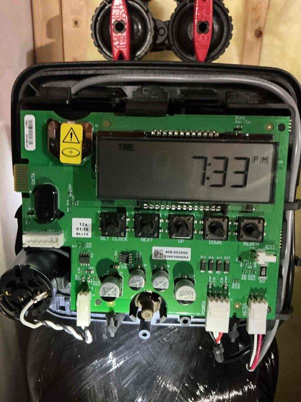 Responded to service call for water softener experiencing clock malfunction causing premature regeneration cycles that interfered with Moen flow system operation and resulted in water shutoff. Upon inspection of dual-tank water softener system, confirmed control head clock was running fast, triggering regeneration approximately 14 hours ahead of programmed schedule. Opened control panel to examine internal circuit board and timer mechanism, verified fast-running clock issue through digital display diagnostics. Documented equipment condition and control head malfunction through photographs. Processed warranty claim for defective timer components to resolve clock accuracy issue and restore proper regeneration cycle timing.