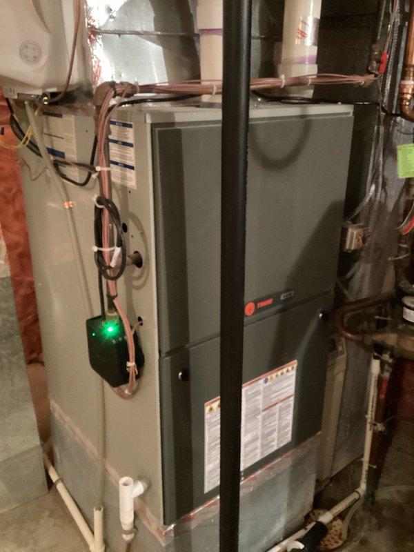 Responded to no cooling complaint on recently installed system. Upon inspection, discovered zoning system misconfiguration with main level thermostat set to cooling mode while lower level thermostat was set to heating mode, creating conflicting calls to the zone control board. Verified zone board and dampers were functioning properly. Educated homeowner on proper thermostat operation for dual-zone system to achieve desired temperature setpoints of 74° upstairs and 71-72° on lower level.