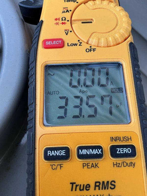 Completed annual AC maintenance tune-up on 14-year-old system under family rewards agreement. Performed comprehensive inspection, verified system operation with multimeter readings showing 33.51°F supply temperature, confirmed thermostat functionality displaying 68° room temperature with proper communication, and recommended hard start kit installation and comfort advisor consultation for aging equipment optimization.
