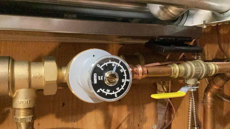 Responded to a no-cooling call on a 7-year-old Trane system and a non-functioning NTI boiler. Upon inspection, found the air handler's water sensor tripped, preventing AC operation. Diagnosed the condenser, contactor, capacitor, compressor, coil, wiring, and refrigerant levels—all within normal parameters. Replaced the faulty wet sensor and wired it back into the system, restoring AC to normal operation. Addressed the boiler displaying a 67 error code due to low water pressure at 12 PSI. Adjusted the auto-fill valve to increase system pressure to 16 PSI and set it to maintain proper pressure. Purged air from the domestic heating loop and pump, reset the boiler, and cycled the system to verify proper operation. Both the air conditioning and boiler systems restored to full functionality.