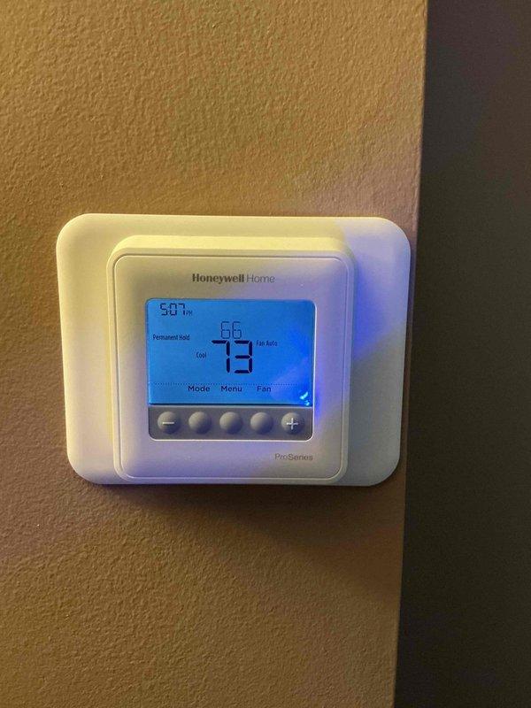 Responded to service call for air conditioning system not operating properly. Upon diagnostic evaluation, identified failed thermostat as root cause of cooling malfunction. Removed existing defective thermostat and installed new Honeywell Home ProSeries programmable thermostat. Verified proper wiring connections, programmed unit settings, and tested system operation to confirm cooling functionality restored. System now operating within normal parameters.