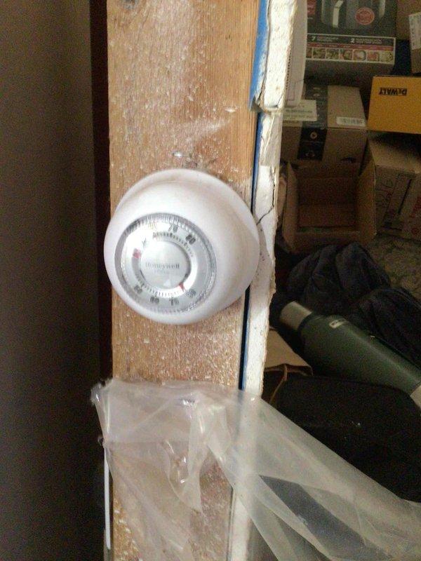 Responded to no cooling complaint on 14-year-old AC unit with reported loud knocking noise at startup and thermostat programming issues. Upon arrival, discovered property had separate thermostats for heating and cooling systems. Found analog heating thermostat dial set to 90 degrees, which was preventing cooling system from operating effectively. AC unit was cycling on properly but heat thermostat setting was overriding cooling function. Adjusted heating thermostat to lowest setting, verified AC unit engaged and began cooling properly. Confirmed system is now operating within normal parameters and providing adequate cooling to occupied space.