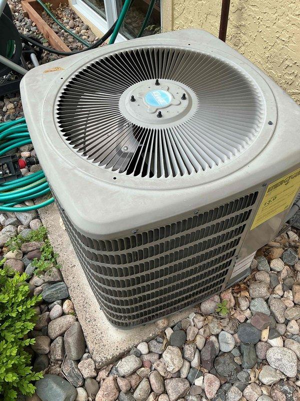 Responded to no cooling call on 12-year-old Goodman air conditioning system. Diagnosed outdoor condenser unit not receiving 24-volt power supply from indoor unit. Upon inspection, discovered control wiring had been cut, likely during recent basement renovation that included finished ceiling installation and thermostat relocation. Recommended customer contact licensed electrician to run new low-voltage control wire from air handler to condenser unit to restore system operation.