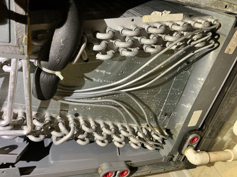 Responded to no cooling complaint on 6-year-old Goodman system installed in 2020. Upon arrival, homeowner reported unit began cooling after cleaning outdoor coil, but diagnostic testing revealed low refrigerant charge. System pressures measured 263 psi high side with 1°F subcooling and LSAT of 87°F, and 99 psi low side with 32°F superheat and VSAT of 31°F. Delta-T measured 20°F across evaporator coil. Verified blower operation, air filter condition, and outdoor coil cleanliness were all satisfactory. Testing confirmed refrigerant undercharge indicating potential leak in system. Presented three-step diagnostic plan option involving UV dye injection, refrigerant charge, and follow-up leak detection inspection. Homeowner declined immediate repair and requested written estimate for consideration.