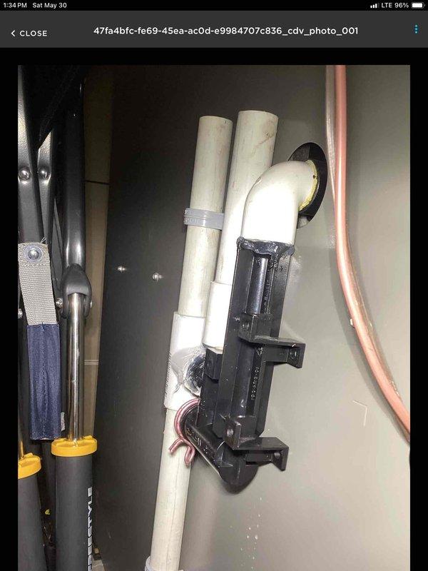 Responded to water leak complaint at furnace location causing significant basement flooding and property damage. Upon inspection, discovered the air conditioning unit's condensate drain hose had become dislodged from the drain trap on the furnace. This disconnection prevented proper drainage, causing the drain pan to overflow and discharge water throughout the basement area. Repositioned the drain hose properly into the trap, restoring correct drainage function. Verified condensate flow was operating correctly after repair. System returned to normal operation with no further leakage observed.